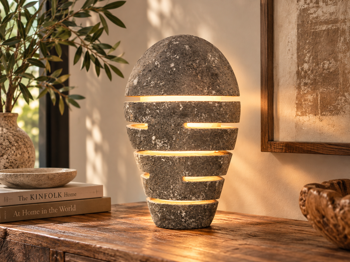 Lampe en pierre allumée, lumière filtrant par les rainures horizontales