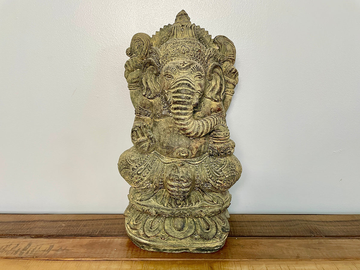 Stone Ganesh statue seated on a lotus base, seen from the front