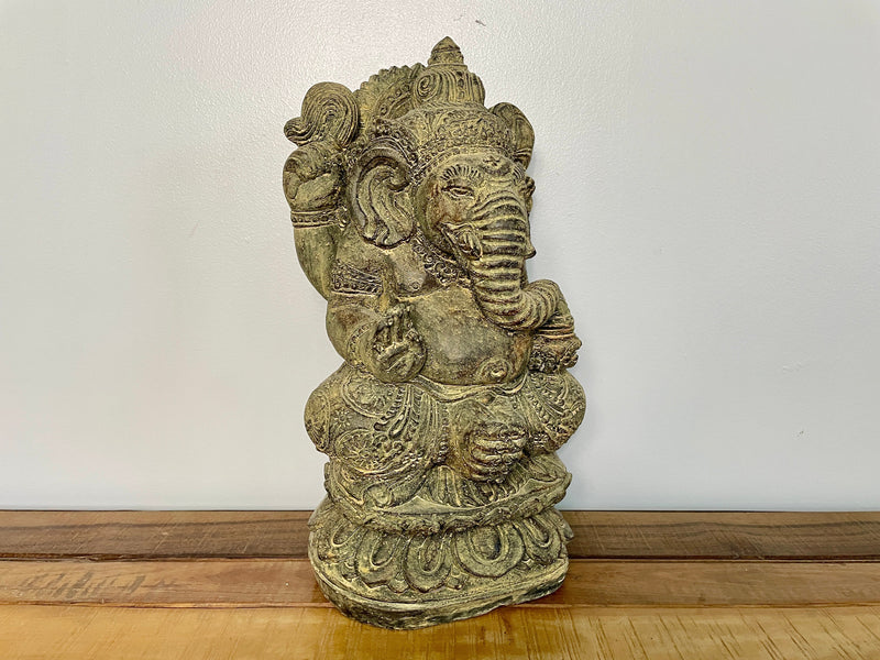 Stone Ganesh statue, three-quarter view, carved headdress and jewellery