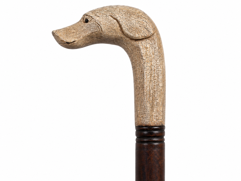 Cane handle carved as a dog's head, light wood on a dark shaft